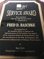 Photo of Defense Research Institute Service Award presented to Fred D. Raschke
